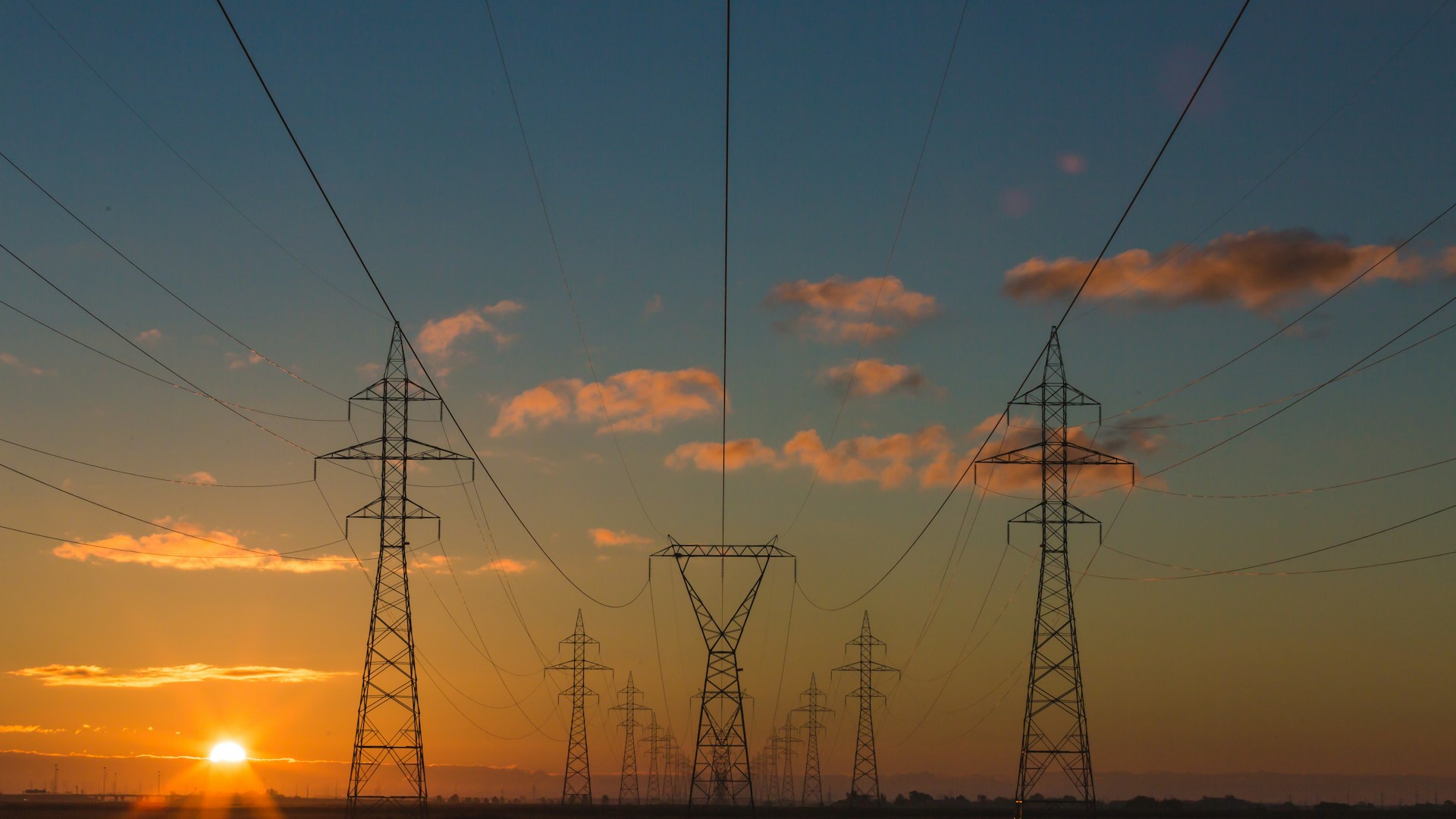 Electric pylons at sunset — utilities infrastructure